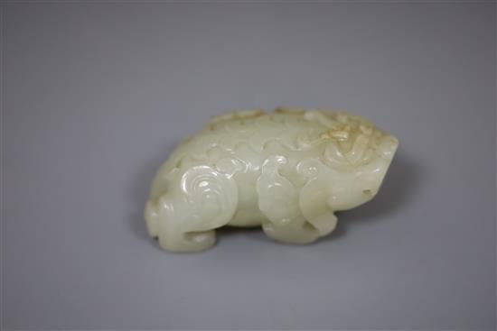 A Chinese pale celadon jade figure of lion-dog, bixi, 17th century, L. 6.8cm, wood stand